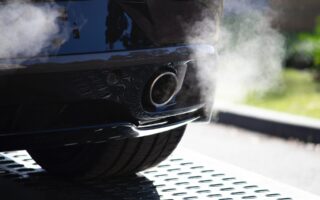 Exhaust smoke emitting from Ford car